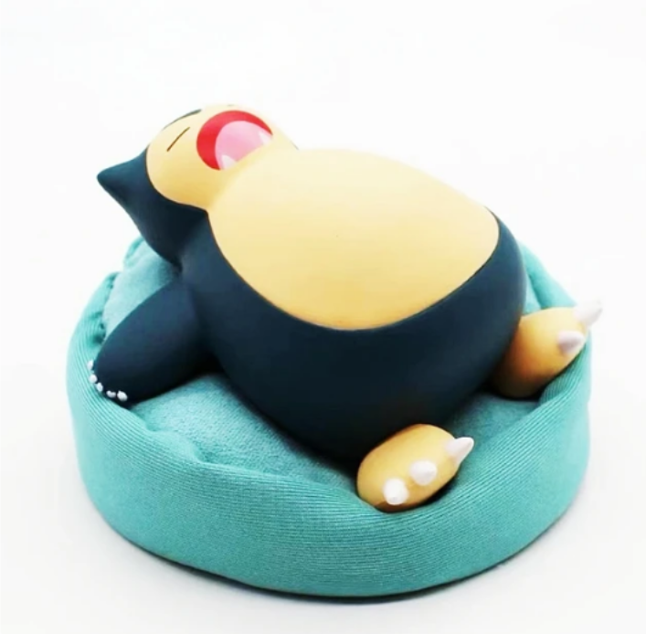 Figurine Pokémon endormi avec coussin