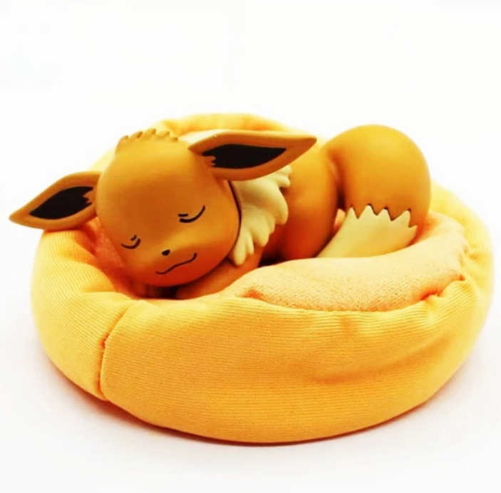 Figurine Pokémon endormi avec coussin