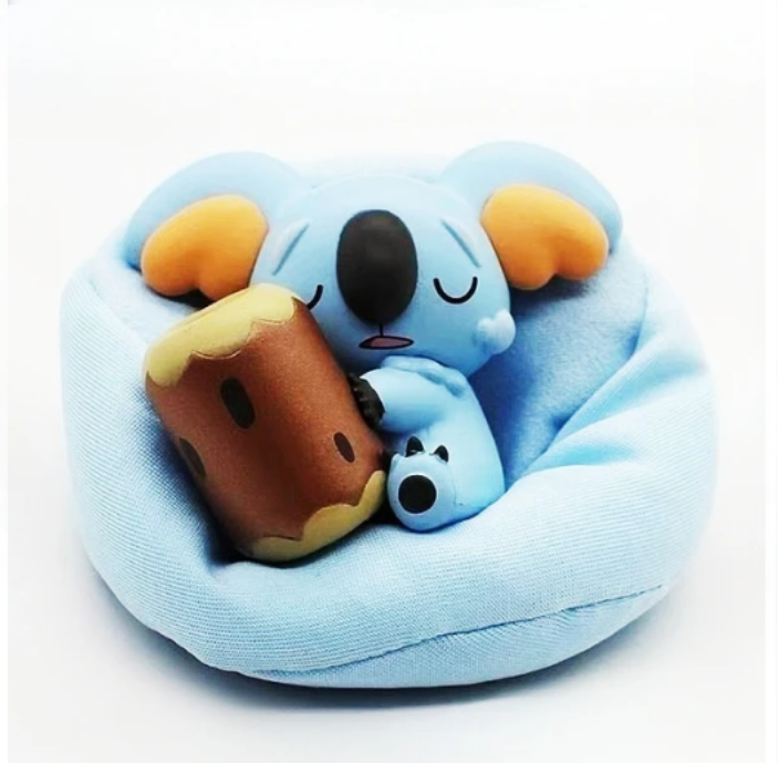 Figurine Pokémon endormi avec coussin