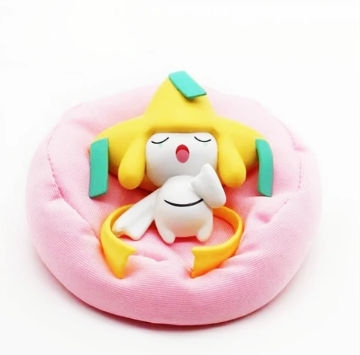 Figurine Pokémon endormi avec coussin