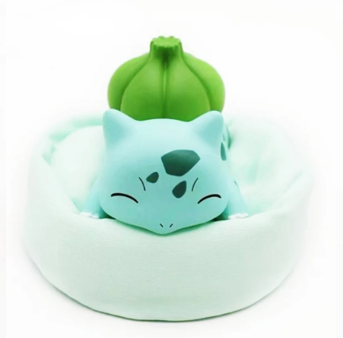 Figurine Pokémon endormi avec coussin